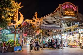 Busy street at Shilin Night Market with food stalls